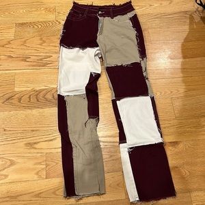 Patchwork jeans with maroon, white, and tan patches